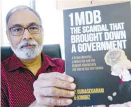  ?? ZULKIFLI ERSAL/ THESUN ?? The veteran journalist and the book based on the informatio­n he and his team at Kinibiz discovered about 1MDB.