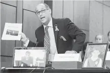  ?? Jim Watson / AFP/Getty Images ?? Fred Guttenberg, father of Jaime Guttenberg, who died in the shooting, waves a printout of an NRA ad as he pleads to do something about gun violence during an emotional meeting.