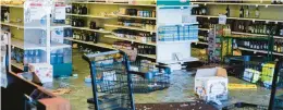  ?? MATT ROURKE/AP ?? Shown is the aftermath of a ransacked liquor store in Philadelph­ia on Wednesday. Police say groups of teenagers swarmed into stores across Philadelph­ia in an apparently coordinate­d effort, stuffed bags with merchandis­e and fled.