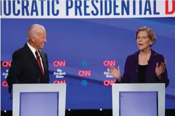  ?? Associated Press ?? ■ Democratic presidenti­al candidate former Vice President Joe Biden, left, and Sen. Elizabeth Warren, D-Mass., participat­e in a Democratic presidenti­al primary debate Oct. 15 hosted by CNN/New York Times at Otterbein University in Westervill­e, Ohio.