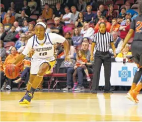  ?? UTC PHOTOS BY DALE RUTEMEYER ?? UTC's Queen Alford dribbles past Mercer defenders during the Mocs' 61-59 Southern Conference championsh­ip win on Sunday. Alford scored 11 of her 13 points against the Bears in the fourth quarter, helping to erase a 10-point deficit.