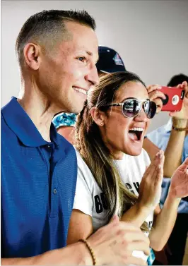  ?? MELANIE BELL / THE PALM BEACH POST ?? Marine Corps veteran and cancer survivor Brian Lowe and his wife, Viviana, react to seeing the backyard at their new home. “The patio is amazing. I love to read outside so the hammock is perfect,” Brian Lowe wrote.