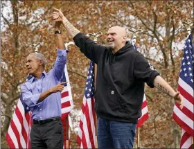  ?? AP PHOTO/GENE J. PUSKAR ?? Former President Barrack Obama, left, finishes his remarks and welcomes Pennsylvan­ia Lt. Gov. John Fetterman, a Democratic candidate for U.S. Senate, to the stage during a campaign rally in Pittsburgh on Saturday.