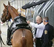  ?? HANS DERYK — THE ASSOCIATED PRESS ?? An honour guard horse is prepared to carry the symbolic empty boots prior to a memorial service for FBI Special Agent Laura Schwartzen­berger Feb. 6in Miami Gardens, Fla.