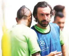  ?? — AFP photo ?? Pirlo (right) talks with Chilean team mate midfielder Arturo Pardo Vidal during a training session at the Juventus Stadium in Turin in this June 1, 2015 file photo.