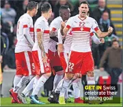  ??  ?? GET IN Swiss celebrate their winning goal