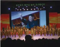  ?? (Yariv Tal) ?? KOREAN DICTATOR Kim Jong-un waves from a giant video screen during a recent military-themed spectacula­r in Pyongyang.