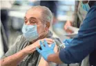  ?? GREG LOVETT/USA TODAY NETWORK FILE ?? A man receives a COVID-19 vaccine in Delray Beach, Fla., on Dec. 30.