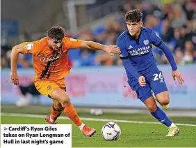  ?? ?? Cardiff’s Ryan Giles takes on Ryan Longman of Hull in last night’s game