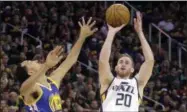  ?? RICK BOWMER — THE ASSOCIATED PRESS ?? FILE - In this May 6, 2017, file photo, Utah Jazz forward Gordon Hayward (20) shoots as Golden State Warriors guard Shaun Livingston (34) defends in the second half during Game 3of the NBA basketball second-round playoff series in Salt Lake City.