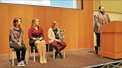  ?? SUBMITTED ?? Project Lead the Way Engineerin­g Instructor Brian Iselin and students discuss their robot project. From left, Soleil Piros, Megan Gregg and Lindsey Wood