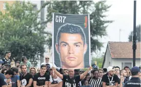  ??  ?? Fans welcome Ronaldo to Juventus’ Allianz Stadium.