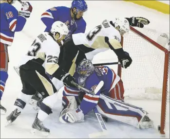  ?? Julie Jacobson/Associated Press photos ?? Nick Spaling (13) tips in a shot as he and Steve Downie storm New York Rangers goalie Henrik Lundqvist to tie the score in the second period.