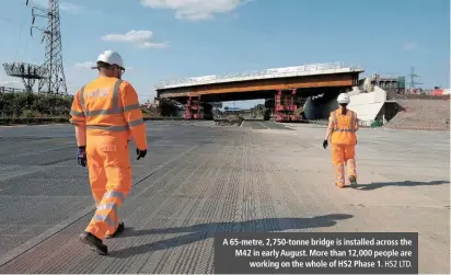  ?? HS2 LTD. ?? A 65-metre, 2,750-tonne bridge is installed across the M42 in early August. More than 12,000 people are working on the whole of HS2 Phase 1.