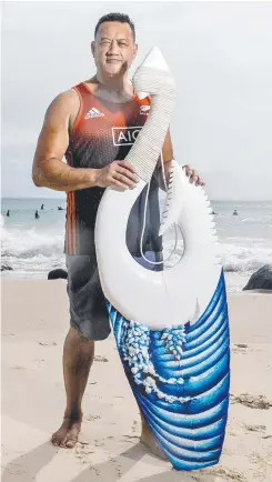  ?? Picture: JERAD WILLIAMS ?? Aylmer Kenny shows off one of his Maori-inspired carved surfboards, a hobby that has now turned into a full-time job.