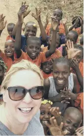  ??  ?? Lisa Seferi with children she met during their visit with the charity set up in tribute to Denise Robertson.