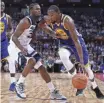  ?? ZHONG ZHI, GETTY IMAGES ?? The Warriors’ Kevin Durant dribbles past Andrew Wiggins in Shenzhen.