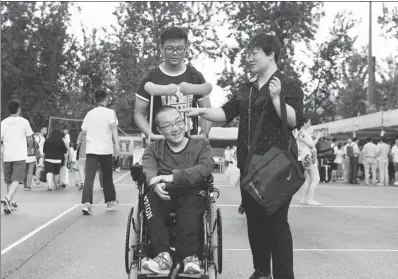  ?? HAO YI / FOR CHINA DAILY ?? Wei Xiang, a freshman from Gansu province admitted to Beijing’s Tsinghua University, arrived to register with his mother on Wednesday. Confined to a wheelchair, he asked the school to allow him to bring his mother to the campus. Tsinghua agreed, and...