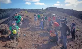  ?? (AFP) ?? Astronauts and geologists of the European Space Agency work on the summit of an ancient volcano during a training programme to learn how to explore the Moon and Mars, in the Canary island of Lanzarote