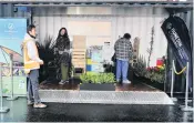  ??  ?? Fauna fun . . . Dunedin City Council policy analyst Jun Sugishita (left) tells revellers about the council’s popup garden (right), which showed how to make backyards attractive for wildlife and people.