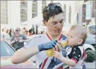  ?? PICTURE: BRUCE ROLLINSON ?? THIRSTY WORK: Rotherham’s Ben Swift gives his son a drink at the finish of the Tour de Yorkshire in Leeds.