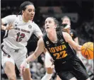  ?? ?? Tony Gutierrez The Associated Press Iowa’s Caitlin Clark drives by South Carolina’s Brea Beal on Friday during her second straight 40-point game.