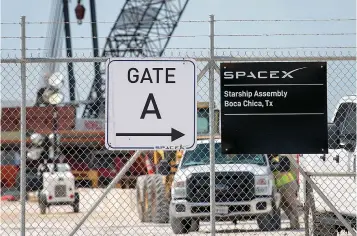  ?? Tribune News Service ?? ■ A gated entrance by a prototype of SpaceX’s Starship spacecraft leads to the company’s Texas launch facility in Boca Chica near Brownsvill­e, Texas. The Starship is a massive vehicle meant to take people to the moon, Mars and beyond.