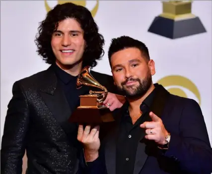  ?? Frederic J. Brown/AFP/Getty Images ?? Dan Smyers, left, and Shay Mooney of musical duo Dan + Shay with their award for best country duo/group performanc­e in the press room during the 61st Annual Grammy Awards on Sunday in Los Angeles.