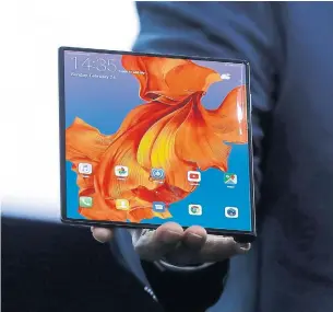  ?? MANU FERNANDEZ THE ASSOCIATED PRESS ?? Huawei CEO Richard Yu displays the new Mate X foldable 5G smartphone at the Mobile World Congress, in Barcelona, where the company had an outsize presence amid tension with the U.S.