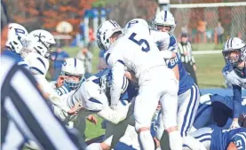  ?? TERRILL COVEY ?? St. Thomas Aquinas’ Trent Salyards (7) and and Sam Grondin (5) combine for a tackle during a Division II semifinal in Pelham. Both were named Division II all-state players this season.