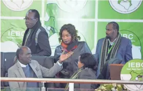  ?? SAYYID ABDUL AZIM/AP ?? Electoral Commission Chairman Wafula Chebukati, left, chats with IEBC commission­ers Friday in Nairobi.