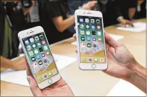  ?? JIM WILSON / NEW YORK TIMES 2017 ?? Apple’s iPhone 8 (left) and 8 Plus are displayed in September. Although phone sales have slowed, the Cupertino, Calif.-based tech giant reported strong financial results.