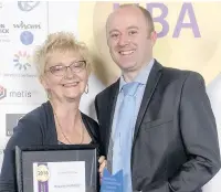  ??  ?? Yvonne Robins of Haworth Art Gallery collecting the Hyndburn Business Award from Philip Woodfield