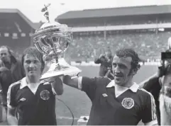  ??  ?? 0 Danny Mcgrain, right, with Kenny Dalglish celebrate Scotland’s win over England in 1976 which clinched the British Championsh­ip.