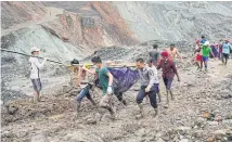  ?? AFP ?? Rescuers recover bodies near the landslide area of the jade mining site in Hpakant in Kachin state on Thursday.