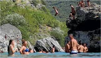  ?? PHOTO: REUTERS ?? Swinners cool off in the Cijevna river near Tuzi as a heatwave hits Montenegro. Last year set global weather records and some areas are already looking at extremes in 2017.