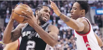  ?? NATHAN DENETTE/THE CANADIAN PRESS ?? San Antonio Spurs’ forward Kawhi Leonard, left, being defended by Toronto Raptors’ guard DeMar DeRozan during a game in Toronto in 2015. The two players were the major pieces in a trade announced between the teams on Wednesday.