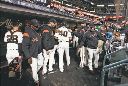  ?? Photos by Scott Strazzante / The Chronicle ?? Madison Bumgarner returns to the dugout after retiring the Mets on Thursday in perhaps his last appearance for the team.