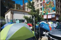  ?? JANE TYSKA — BAY AREA NEWS GROUP ?? Tents are seen near a sanctioned and fenced-in homeless encampment across from City Hall in San Francisco on May 19. The sanctioned camp has socially-distanced spaces, hand washing stations, bathrooms and 24-hour security.