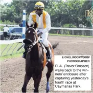  ?? LIONEL ROOKWOOD/ PHOTOGRAPH­ER ?? ELAL (Trevor Simpson) walks back to the winners’ enclosure after capturing yesterday’s fourth race at Caymanas Park.