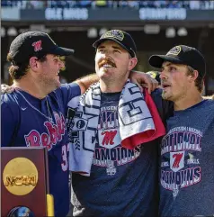  ?? JOHN PETERSON/ASSOCIATED PRESS ?? Mississipp­i stars (from left) Ben Van Cleve, Tim Elko and Justin Bench watch the closing video after a 4-2 victory over Oklahoma in Game 2 of the College World Series finals on Sunday. The Rebels, who were stumbling at midseason, won 10 of 11 postseason games.