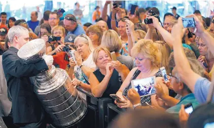  ?? AP FILE ?? Hockey fans flock to get a close-up look at the Stanley Cup, which was on display at the MGM Grand Hotel & Casino on the Las Vegas Strip last June.