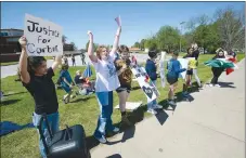  ?? ANDY SHUPE NWA DEMOCRAT-GAZETTE ?? Students from Farmington junior high and high schools chant Friday during a protest along Main Street near the Farmington Junior High School after a student was allegedly attacked Tuesday, April 27, at the school by at least one fellow student.