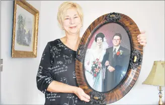  ?? JIM DAY/SALTWIRE NETWORK ?? Orlanda Drebit of Appin Road, P.E.I., holds a wedding day photo of her and her late husband, Don. She is thrilled to have just tracked down her wedding and engagement rings, among others, after forgetting where she hid them in 2015.