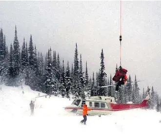  ?? Golden and District Search and Rescue ?? Crews with Golden and District Search and Rescue airlift a victim who was injured in an avalanche from a remote mountain slope northeast of Golden on Monday.