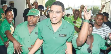  ?? FILE ?? JLP leader, Prime Minister Andrew Holness, surrounded by supporters.