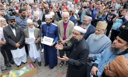  ?? AP ?? Members of the British Muslim Forum and religious leaders from Christian and Jewish faiths pay their respects at St Ann’s Square in Manchester, England, on Sunday. —