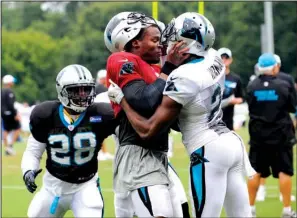  ??  ?? SUMMER SQUABBLE: Carolina teamates Cam Newton ( 1) and Josh Norman ( 24) scuffle at the team’s training camp Monday in Spartanbur­g, S. C. Newton, the Panthers’ No. 1 quarterbac­k, retaliated after Norman stiff- armed him during an intercepti­on return.