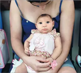  ?? Katie Falkenberg Los Angeles Times ?? A BRAZILIAN mother with her baby, who was born with microcepha­ly, a brain abnormalit­y often seen in children of women infected with Zika while pregnant.