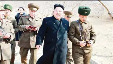  ?? KCNA VIA KNS/AFP ?? North Korean leader Kim Jong-un (centre) inspects the Sin Islet defence company in Kangwon province, while his younger sister Kim Yo-Jong (third left) follows.